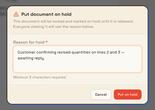 A dialog titled Put document on hold with a reason field and a Put on hold confirm button.