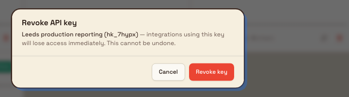 Revoke API key confirmation dialog naming the key and warning that access stops immediately.