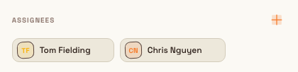 A task's Assignees section showing two assignee tags with avatars after assignment, with a confirmation that assignees were updated.