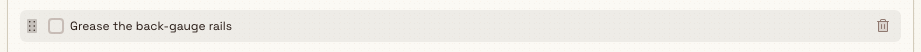 A checklist item row on hover, showing a drag handle on the left and a delete control on the right.
